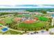 Aerial view of a sports complex featuring baseball and sports fields, surrounded by greenery at 3567 Chestnut Dr. # 3567, Myrtle Beach, SC 29577