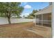 View of the house from the backyard, featuring a screened porch, privacy fence, and concrete pad at 3567 Chestnut Dr. # 3567, Myrtle Beach, SC 29577