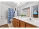 Bright bathroom featuring double sinks and a shower with blue patterned curtain at 3567 Chestnut Dr. # 3567, Myrtle Beach, SC 29577