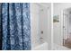 Clean bathroom showcasing a shower/tub with a blue floral curtain and an open doorway at 3567 Chestnut Dr. # 3567, Myrtle Beach, SC 29577