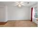 Bright bedroom with a ceiling fan, neutral carpet, and a window with red curtains at 3567 Chestnut Dr. # 3567, Myrtle Beach, SC 29577