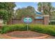 Community entrance sign displaying 'Windsor Gate' amid manicured bushes and shrubbery at 3567 Chestnut Dr. # 3567, Myrtle Beach, SC 29577