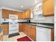 Efficient kitchen featuring wood cabinets, white appliances, and plenty of counter space for food prep at 3567 Chestnut Dr. # 3567, Myrtle Beach, SC 29577