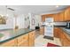 Kitchen featuring wood cabinets, white appliances, a breakfast bar, and views to other parts of the house at 3567 Chestnut Dr. # 3567, Myrtle Beach, SC 29577