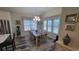 Cozy dining room with a large window, elegant lighting, and a dining table set for six at 372 Leste Rd., Myrtle Beach, SC 29588