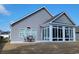 Rear exterior view showcasing sunroom and outdoor seating area and siding at 372 Leste Rd., Myrtle Beach, SC 29588