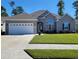 Charming single-story home featuring a two-car garage, well-manicured lawn, and inviting front entrance at 372 Leste Rd., Myrtle Beach, SC 29588