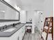 Bathroom featuring dual sinks, a seated make-up area, and a small wooden storage rack at 39 Lazy Hammock Trail, Pawleys Island, SC 29585