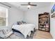 Bright bedroom with a small bookshelf and a throw pillow saying 'Life is Better at the Beach' at 39 Lazy Hammock Trail, Pawleys Island, SC 29585