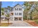 Charming three-story beach house with a covered parking area and traditional architectural details at 39 Lazy Hammock Trail, Pawleys Island, SC 29585