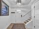 Bright foyer features a staircase, wood-look flooring, and a decorative painting at 39 Lazy Hammock Trail, Pawleys Island, SC 29585