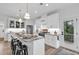 Bright kitchen with a large island, pendant lighting, stainless steel appliances, and white cabinetry at 39 Lazy Hammock Trail, Pawleys Island, SC 29585