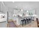 Modern kitchen features a large island with seating and white cabinets at 39 Lazy Hammock Trail, Pawleys Island, SC 29585