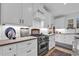 Modern kitchen with stainless steel stove, white cabinetry, and stylish decor at 39 Lazy Hammock Trail, Pawleys Island, SC 29585