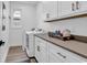 Practical laundry room with modern washer and dryer, and ample counter space at 39 Lazy Hammock Trail, Pawleys Island, SC 29585