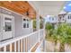 Front porch with outdoor fan and decorated with a palm tree at 39 Lazy Hammock Trail, Pawleys Island, SC 29585