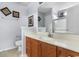 Bathroom with light countertop, wooden vanity, toilet, framed art, and large mirror at 401 Barton Loop, Myrtle Beach, SC 29579