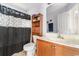 Bathroom featuring a black shower curtain, wooden vanity, white sink, and large mirror at 401 Barton Loop, Myrtle Beach, SC 29579