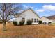 View of the back of the home showcasing the rear windows and well-maintained lawn at 401 Barton Loop, Myrtle Beach, SC 29579