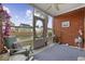 Relaxing screened porch with brick walls overlooking a serene pond and neighboring houses at 4142 Hibiscus Dr. # 103, Little River, SC 29566