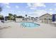 Community swimming pool surrounded by lounge chairs and a white fence at 4142 Hibiscus Dr. # 103, Little River, SC 29566