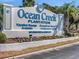 The entrance sign to Ocean Creek Plantation with vacation rentals and oceanfront resort information at 415 Ocean Creek Dr. # 2159, Myrtle Beach, SC 29572