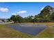 Community basketball court situated near a playground, surrounded by lush greenery on a sunny day at 4387 Heartwood Ln., Myrtle Beach, SC 29579