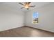 Bright bedroom featuring wood-look floors, a ceiling fan, and a window providing natural light at 4387 Heartwood Ln., Myrtle Beach, SC 29579