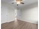 Spacious bedroom featuring a ceiling fan, neutral walls, and wood-look floors at 4387 Heartwood Ln., Myrtle Beach, SC 29579