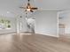 Open-concept living room features wood floors, a ceiling fan, and an entry to the kitchen at 4387 Heartwood Ln., Myrtle Beach, SC 29579