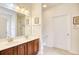 Bathroom featuring double sink vanity, framed mirror, and tiled floor with a view of the shower area at 440 Woodpecker Ln. # A, Murrells Inlet, SC 29576