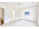 Bright bedroom featuring neutral carpet and an ensuite bathroom through an open door at 440 Woodpecker Ln. # A, Murrells Inlet, SC 29576