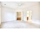 Bright bedroom featuring neutral carpet with open doors to hallway and bathroom at 440 Woodpecker Ln. # A, Murrells Inlet, SC 29576