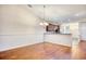 Open dining room with wood floors and view of the kitchen at 440 Woodpecker Ln. # A, Murrells Inlet, SC 29576