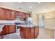 Modern kitchen with stainless appliances, dark cabinets, a center island, and tile flooring at 440 Woodpecker Ln. # A, Murrells Inlet, SC 29576