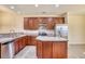 Well-equipped kitchen with dark wood cabinets, stainless steel appliances, and a functional center island at 440 Woodpecker Ln. # A, Murrells Inlet, SC 29576