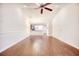 Open living room featuring hardwood floors, ceiling fan and access to the kitchen at 440 Woodpecker Ln. # A, Murrells Inlet, SC 29576