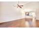 Open living room featuring hardwood floors, ceiling fan and access to the kitchen at 440 Woodpecker Ln. # A, Murrells Inlet, SC 29576