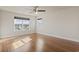 Bright bedroom featuring gleaming hardwood floors, a ceiling fan, and large windows for ample natural light at 445 Mooreland Dr., Myrtle Beach, SC 29588