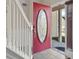 Bright foyer featuring a red front door, tiled floors, and a staircase with white railings at 445 Mooreland Dr., Myrtle Beach, SC 29588