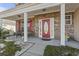 Charming front porch with red door, brick facade, and seating area at 445 Mooreland Dr., Myrtle Beach, SC 29588