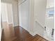 Hallway featuring hardwood floors, coat closet, and staircase leading to the front door at 445 Mooreland Dr., Myrtle Beach, SC 29588