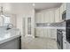 A bright kitchen features white cabinets, stainless appliances, tile backsplash and hardwood floors at 445 Mooreland Dr., Myrtle Beach, SC 29588