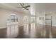 An open living room features hardwood floors, arched doorways and a partial view into the modern kitchen at 445 Mooreland Dr., Myrtle Beach, SC 29588