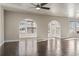 An open living room features hardwood floors, arched doorways, a ceiling fan, and lots of natural light at 445 Mooreland Dr., Myrtle Beach, SC 29588