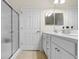 Well-lit bathroom featuring a shower with a glass enclosure, double vanity, and a neutral color palette at 446 Deerfield Links Dr., Surfside Beach, SC 29575