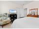 Bedroom with a floral chair, dresser, and a television with a beach scene displayed on the screen at 446 Deerfield Links Dr., Surfside Beach, SC 29575