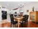 Open-concept dining area with wood table and chairs, seamlessly connected to the kitchen at 446 Deerfield Links Dr., Surfside Beach, SC 29575