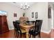 Traditional dining room with wooden table, chandelier, and decorative wall art features a warm and inviting atmosphere at 446 Deerfield Links Dr., Surfside Beach, SC 29575