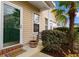 Inviting front porch featuring a decorative welcome mat, potted plants and a tropical palm tree at 446 Deerfield Links Dr., Surfside Beach, SC 29575